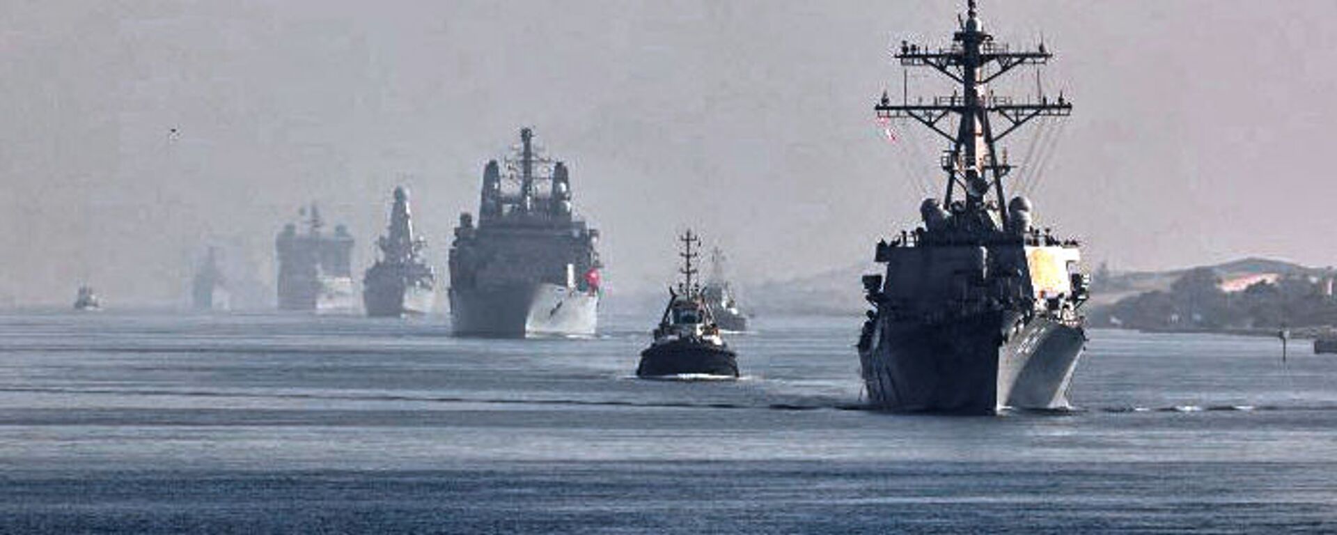 This handout image provided by the official Twitter account of Commodore Steve Moorhouse, Royal Navy, Commander of the UK Carrier Strike Group on July 6, 2021 shows a view of the vessels of the strike group sailing behind the Royal Navy's HMS Queen Elizabeth aircraft carrier through Egypt's Suez Canal. - Sputnik International, 1920, 08.08.2021