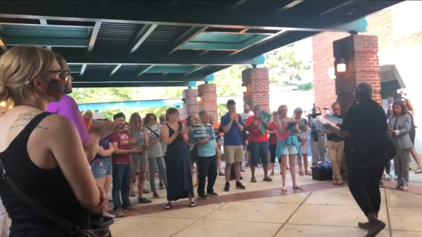 Screenshot from a video allegedly showing Michelle Leete, an ex-vice president of training at Virginia's Parent-Teacher Association, protesting before the Fairfax Schools board, saying that opponents of critical race theory can die - Sputnik International