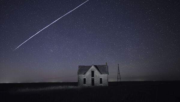 File-In this photo taken 6 May 2021, with a long exposure, a string of SpaceX StarLink satellites passes over an old stone house. - Sputnik International