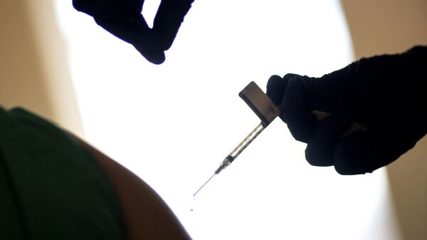 In this Tuesday, Dec. 15, 2020 file photo, a droplet falls from a syringe after a health care worker was injected with the Pfizer-BioNTech COVID-19 vaccine at a hospital in Providence, R.I. - Sputnik International
