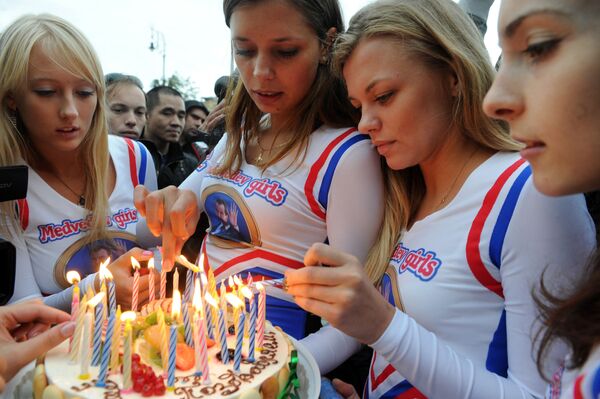 Medvedev Girls, members of an internet community supporting Russia's President Dmitry Medvedev, hold a birthday cake during their staged action marking Medvedev's 46th birthday  in Moscow,  on 14 September 2011.   - Sputnik International
