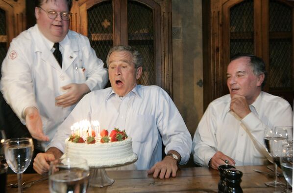 Former President George W Bush, left, prepares to blows out the candles on his birthday cake as he celebrates with Richard M. Daley, right, Mayor of Chicago, at the Chicago Firehouse restaurant, on 6 July 2006, in Chicago, US.   - Sputnik International
