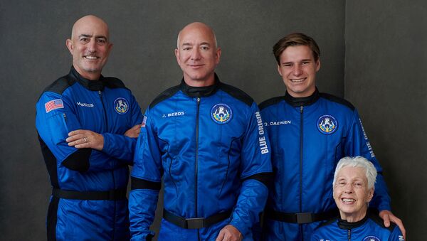 Billionaire Jeff Bezos, founder of ecommerce company Amazon.com Inc, his brother Mark Bezos, a private equity executive, pioneering female aviator Wally Funk and recent Dutch high school graduate Oliver Daemen pose in an undated photograph, ahead of their scheduled flight aboard Blue Origin's New Shepard rocket near Van Horn, Texas, U.S. - Sputnik International