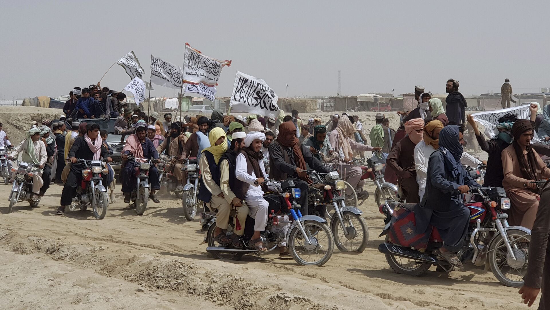 Supporters of the Taliban carry the Taliban's signature white flags in the Afghan-Pakistan border town of Chaman, Pakistan, Wednesday, July 14, 2021 - Sputnik International, 1920, 24.07.2021