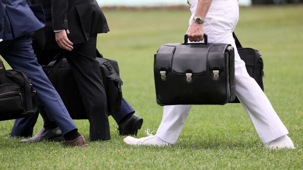 A military aide carries the so-called nuclear football as he walks to board the Marine One helicopter with U.S. President Donald Trump for travel to Florida from the White House in Washington, U.S. May 8, 2019. - Sputnik International