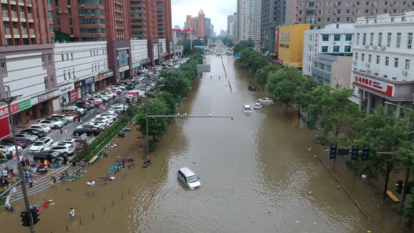 An aerial view shows a flooded road section following heavy rainfall in Zhengzhou, Henan province, July 21.  - Sputnik International