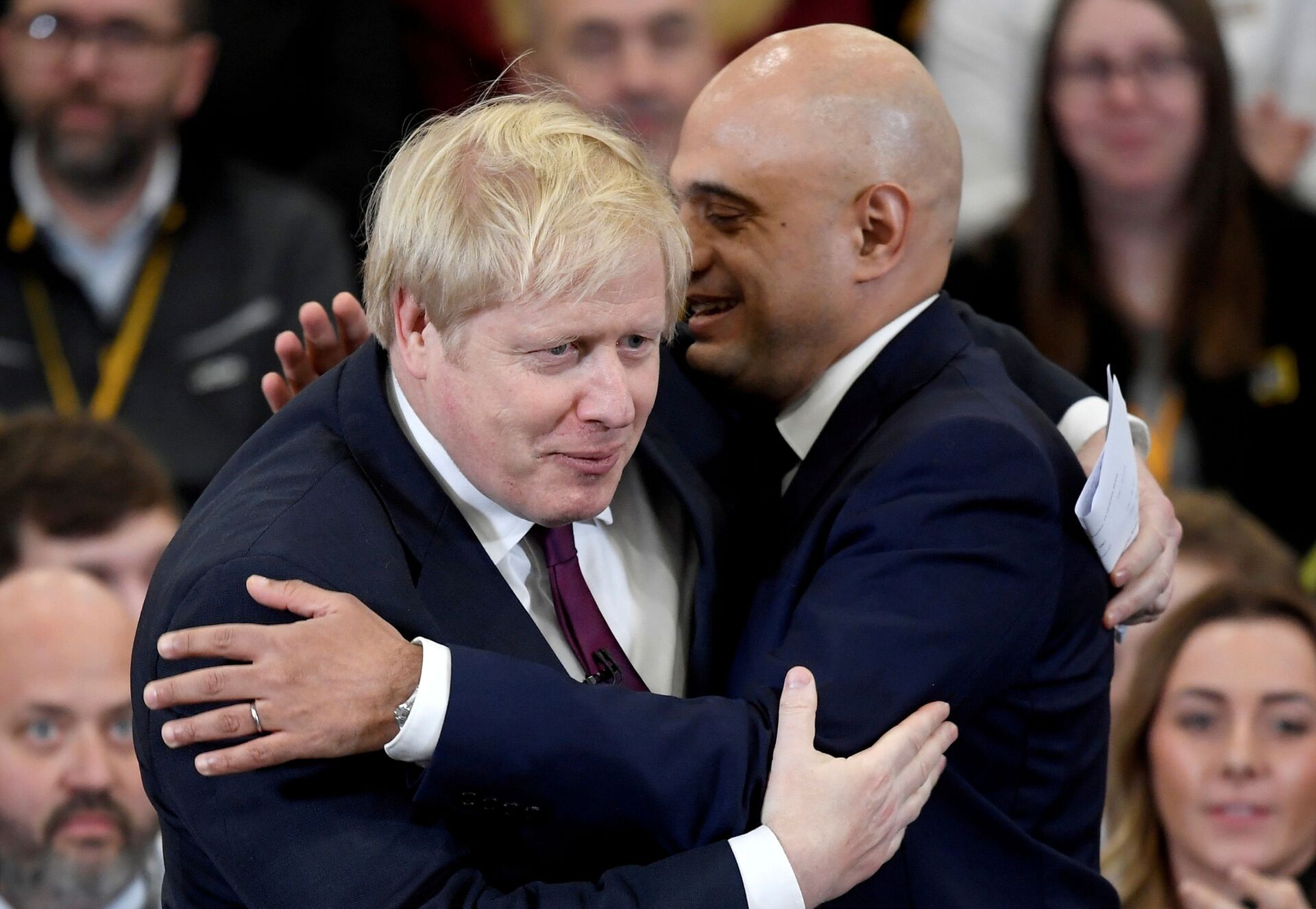 Britain's Prime Minister Boris Johnson is embraced by Britain's Chancellor of the Exchequer Sajid Javid before speaking to the workers as he visits a JCB factory during his general election campaign in Uttoxeter, Britain, December 10, 2019 - Sputnik International, 1920, 08.09.2021