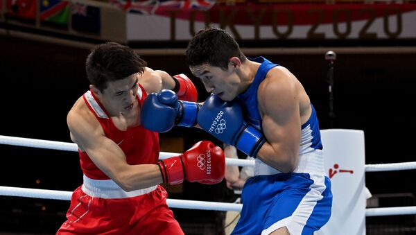 Tokyo 2020 Olympics - Boxing - Men's Lightweight - Last 32 - Kokugikan Arena - Tokyo, Japan - July 25, 2021. Elnur Abduraimov of Uzbekistan in action against Baatarsukh Chinzorig of Mongolia  - Sputnik International