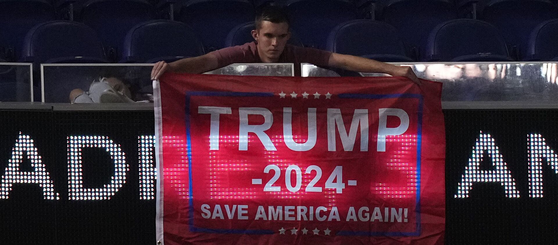 A fan displays a flag in support of former president Donald Trump in the upper deck after the game between the Miami Marlins and the San Diego Padres at loanDepot park - Sputnik International, 1920, 25.07.2021
