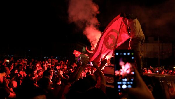 Supporters of Tunisia's President Kais Saied gather on the streets as they celebrate after he dismissed the government and froze parliament, in Tunis, Tunisia July 25, 2021. - Sputnik International
