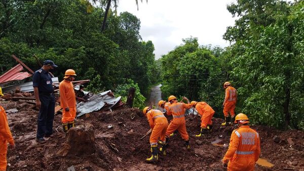 Members of National Disaster Response Force (NDRF) conduct a search and rescue operation after a landslide following heavy rains in Ratnagiri district, Maharashtra state, India, July 25, 2021.  - Sputnik International