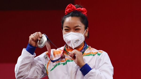 Tokyo 2020 Olympics - Weightlifting - Women's 49kg - Medal Ceremony - Tokyo International Forum, Tokyo, Japan - July 24, 2021. Silver medalist Mirabai Chanu Saikhom of India reacts. - Sputnik International