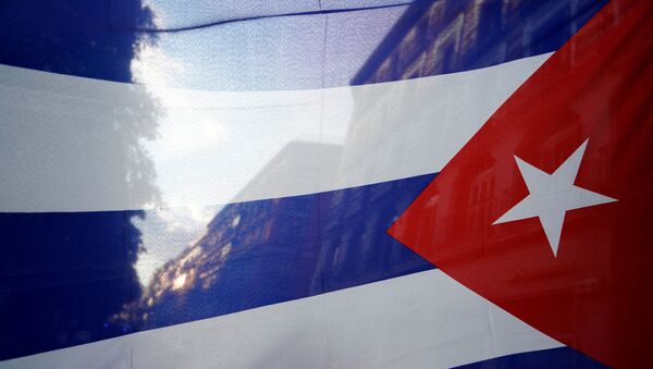 The silhouette of the city is seen through a Cuban flag during a protest against the  U.S. economic embargo in Cuba - Sputnik International