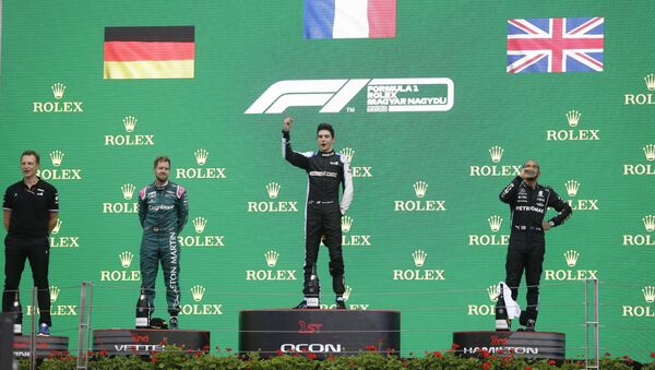 Formula One F1 - Hungarian Grand Prix - Hungaroring, Budapest, Hungary - August 1, 2021 Second placed Sebastian Vettel of Aston Martin, first placed Esteban Ocon of Alpine and third placed Lewis Hamilton of Mercedes on the podium after the race  - Sputnik International