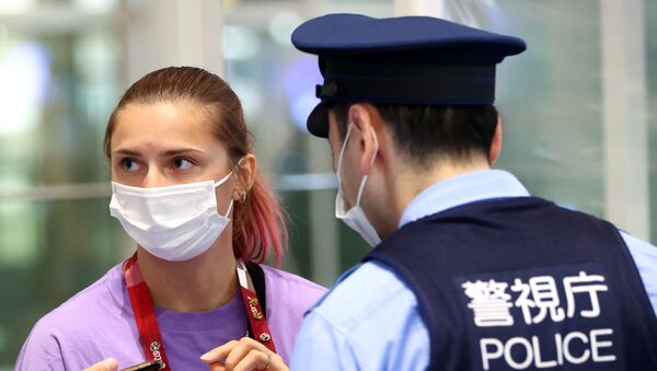 Belarusian sprinter Krystina Tsimanouskaya talks with police officers at Haneda international airport in Tokyo, Japan - Sputnik International