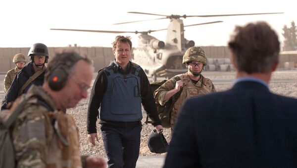 British Prime Minister David Cameron (C) arrives at Lashkar Gah base in Afghanistan on December 6, 2010. Cameron has made an unannounced trip to Afghanistan to demonstrate the growing stability in the country and to see how troops are helping to train up the Afghan security services.  - Sputnik International