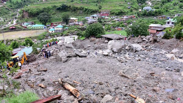 Rescue workers search for survivors after a landslide caused by heavy rains at Rulehar village in the Kangra district of the northern state of Himachal Pradesh, India, July 13, 2021.  - Sputnik International