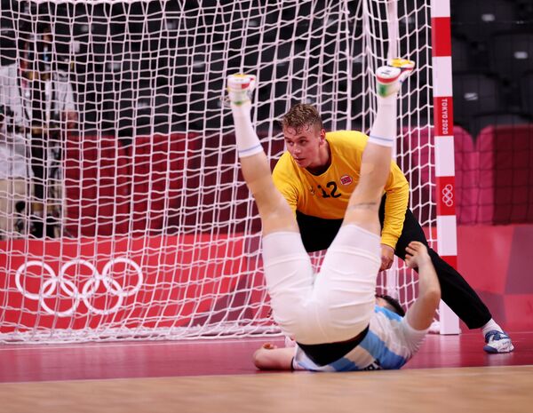 Kristian Skinstad Saeveraas of Norway in action as an Argentinean player falls to the floor. Handball - Men - Group A, Yoyogi National Stadium - Sputnik International