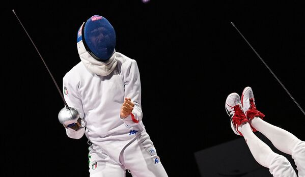 Italy's Enrico Garozzo (L) reacts as Japan's Koki Kano falls down during a men's epee individual qualifying bout.  - Sputnik International