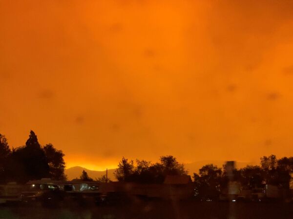 A dark orange sky due to the Dixie fire is seen in Lassen County, California on 5 August 2021 in this screengrab obtained from a social media video. - Sputnik International