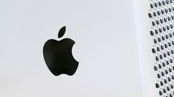 This May 21, 2021 photo shows the Apple logo displayed on a Mac Pro desktop computer in New York.  Apple is planning to scan U.S. iPhones for images of child abuse, drawing applause from child protection groups but raising concern among security researchers that the system could be misused by governments looking to surveil their citizens. - Sputnik International