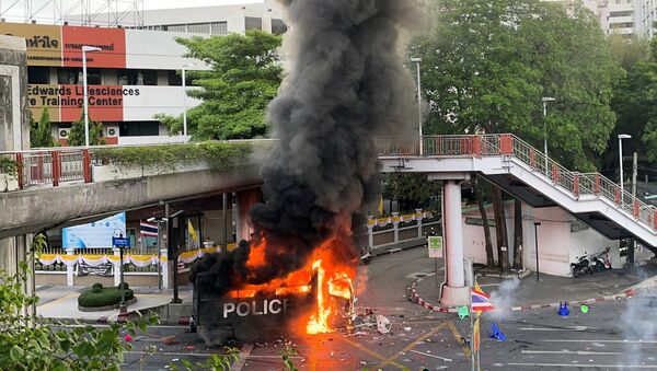 A police vehicle burns during clashes at a protest against what demonstrators call the government's failure in handling the coronavirus disease (COVID-19) outbreak, in Bangkok, Thailand, August 7, 2021. - Sputnik International