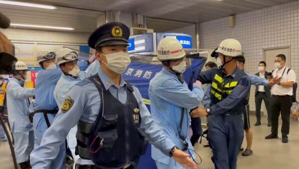 Police escort rescue workers carrying a person through a train station after a knife attack on a train in Tokyo, Japan August 6, 2021 in this still image taken from video obtained by REUTERS   THIS IMAGE HAS BEEN SUPPLIED BY A THIRD PARTY. - Sputnik International