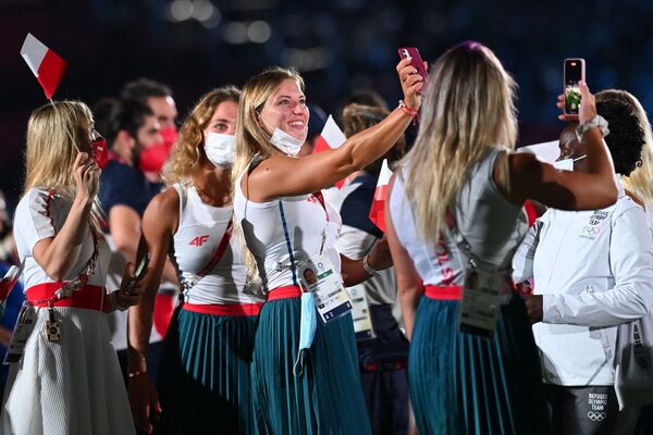 Members of the Polish delegation take pictures as they attend the closing ceremony of the Tokyo 2020 Olympic Games. - Sputnik International