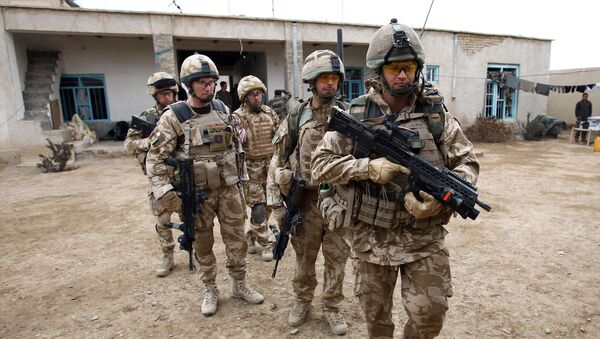 British soldier Lieutenant-Colonel Nick Lock (2L) gathers his soldiers of the 1st Batallion of the Royal Welsh before a patrol in the streets of Showal in Nad-e-Ali district, Southern Afghanistan, in Helmand Province on February 25, 2010 - Sputnik International