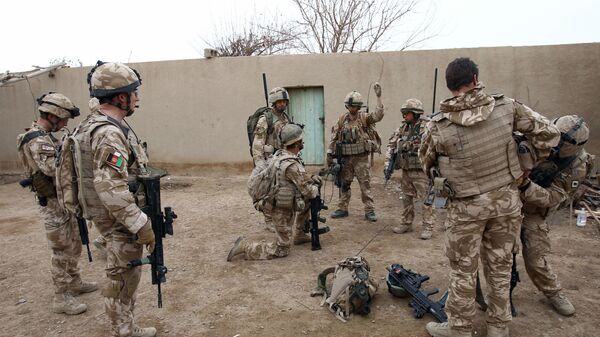 British soldier Lieutenant-Colonel Nick Lock (2L) gathers his soldiers of the 1st Batallion of the Royal Welsh before a patrol in the streets of Showal in Nad-e-Ali district, Southern Afghanistan, in Helmand Province on February 25, 2010 - Sputnik International