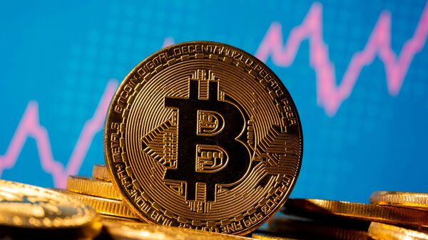 FILE PHOTO: A representation of virtual currency bitcoin is seen in front of a stock graph in this illustration taken November 19, 2020. REUTERS/Dado Ruvic/Illustration/File Photo - Sputnik International