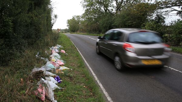 Floral tributes lay on the roadside near RAF Croughton in Northamptonshire, central England on October 10, 2019, at the spot where British motorcyclist Harry Dunn was killed as he travelled along the B4031 on August 27. - Dunn was killed on August 27 when his motorbike collided with a car near a Royal Air Force base in Northamptonshire in central England, which is used by the US military as a communications hub. - Sputnik International