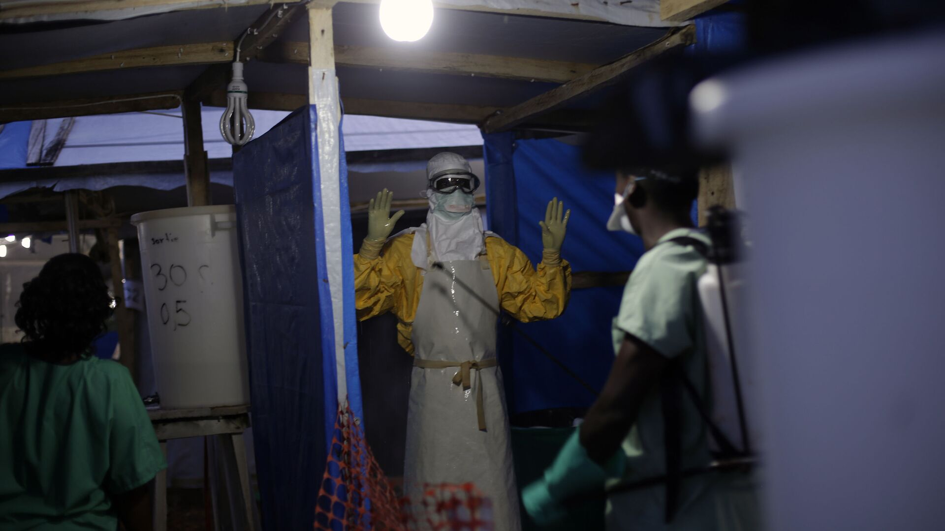 FILE- In this Nov. 20, 2014 file photo, an MSF Ebola heath worker is sprayed as he leaves the contaminated zone at the Ebola treatment centre in Gueckedou, Guinea - Sputnik International, 1920, 09.10.2021