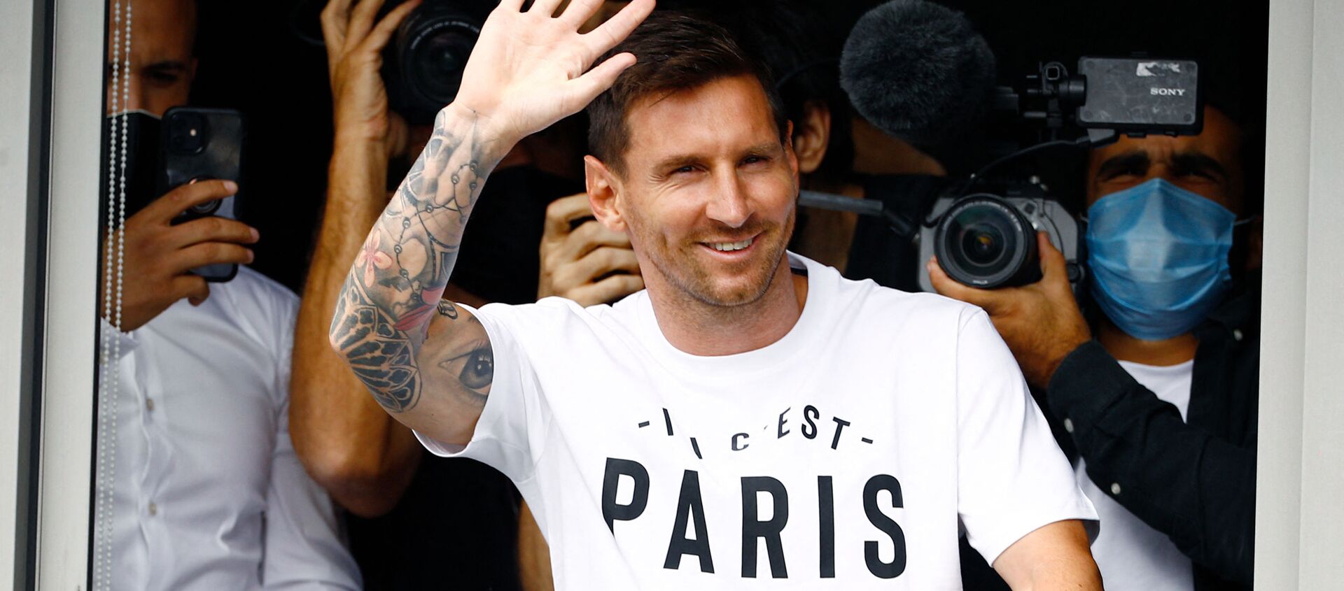 Argentinian football player Lionel Messi waves to supporters from a window after he landed on August 10, 2021 at Le Bourget airport, north of Paris, to become Paris Saint-Germain's new player - Sputnik International, 1920, 10.08.2021