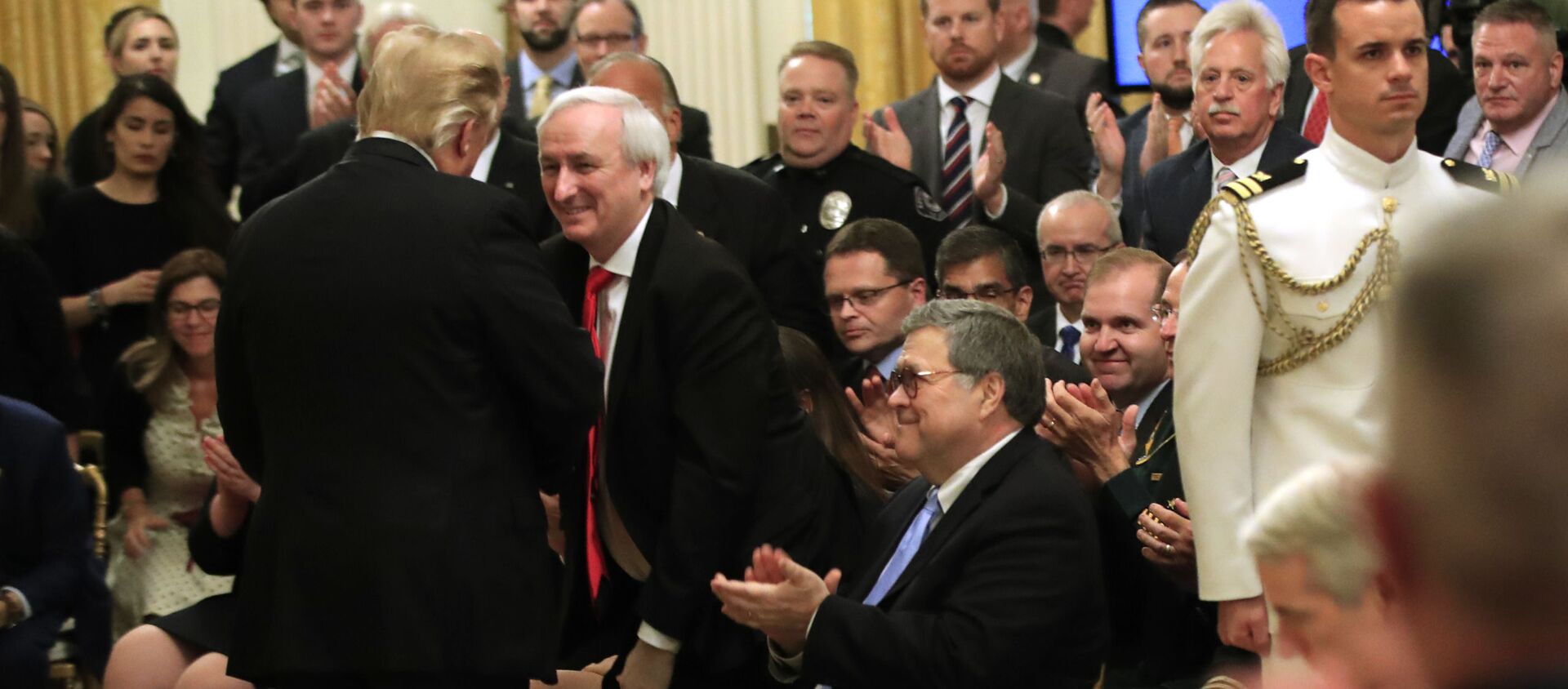 President Donald Trump greets Attorney General William Barr, seated, Deputy Attorney General Jeffrey Rosen, and invited guests during a ceremony awarding the Public Safety Officer Medal of Valor in the East Room of the White House in Washington, Wednesday, May 22, 2019 - Sputnik International, 1920, 11.08.2021