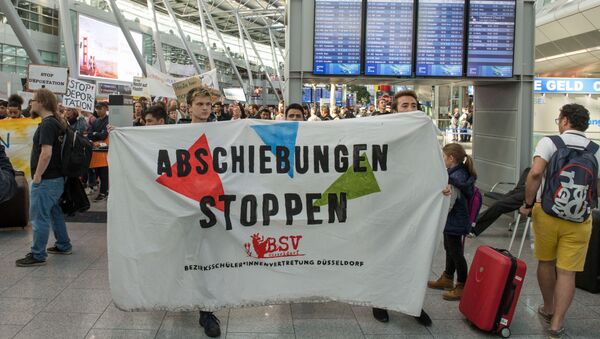 Activists hold a banner reading Stop deportation as they protest against the expulsion of Afghans at the airport Duesseldorf, western Germany, on September 12, 2017. - Sputnik International