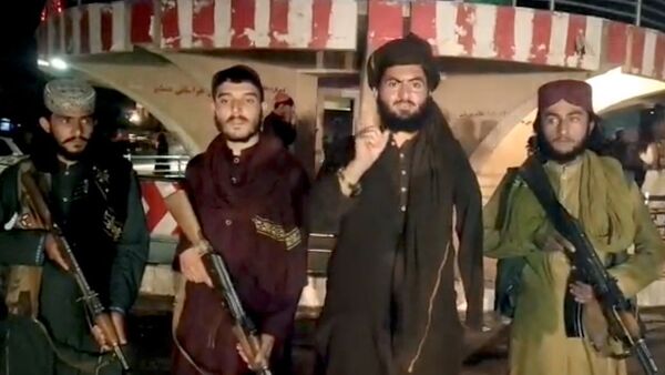 Taliban fighters record a message after seizing Pul-e- Khumri, capital of Baghlan province, Afghanistan, in this still image taken from a social media video, uploaded August 10, 2021 - Sputnik International