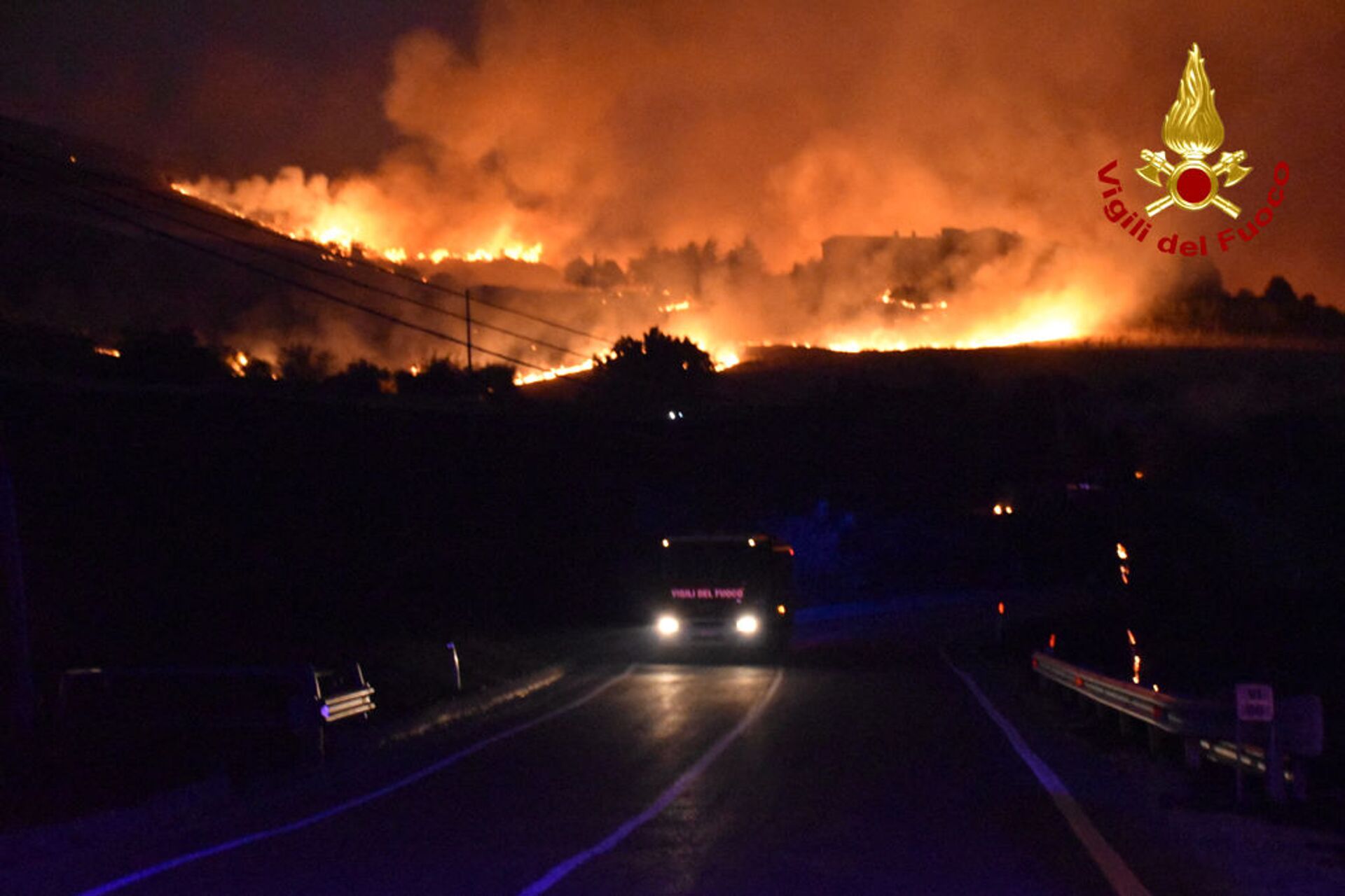 This handout picture taken and released on August 10, 2021 by the Italian Firefighters Vigili del Fuoco shows a firefighter engine driving as a fire rages around Palermo, Sicily, that have forced of people from their homes. - Sputnik International, 1920, 07.09.2021