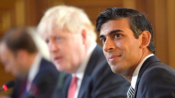 Britain's Chancellor of the Exchequer Rishi Sunak (R) sits beside Britain's Prime Minister Boris Johnson (C) at a Cabinet meeting of senior government ministers at the Foreign and Commonwealth Office (FCO) in London on September 1, 2020.  - Sputnik International