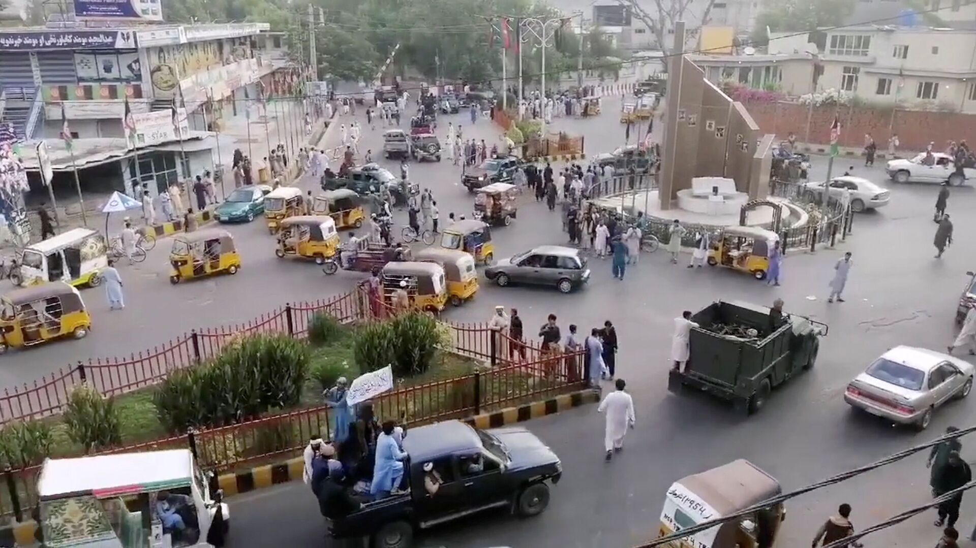 Taliban militants waving a Taliban flag on the back of a pickup truck drive past a crowded street at Pashtunistan Square area in Jalalabad, Afghanistan in this still image taken from social media video uploaded on August 15, 2021. Social media website/via REUTERS THIS IMAGE HAS BEEN SUPPLIED BY A THIRD PARTY. - Sputnik International, 1920, 07.09.2021