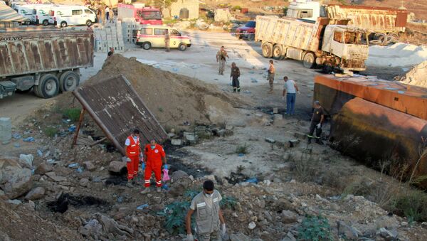 Lebanese army soldiers, civil defense members and rescuers are seen at the site of a fuel tank explosion in Akkar, in northern Lebanon, August 15, 2021. - Sputnik International