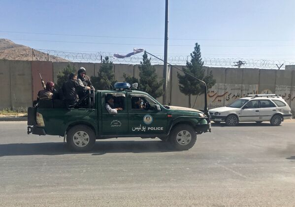Taliban fighters ride on a police vehicle in Kabul, Afghanistan, 16 August 2021.  - Sputnik International