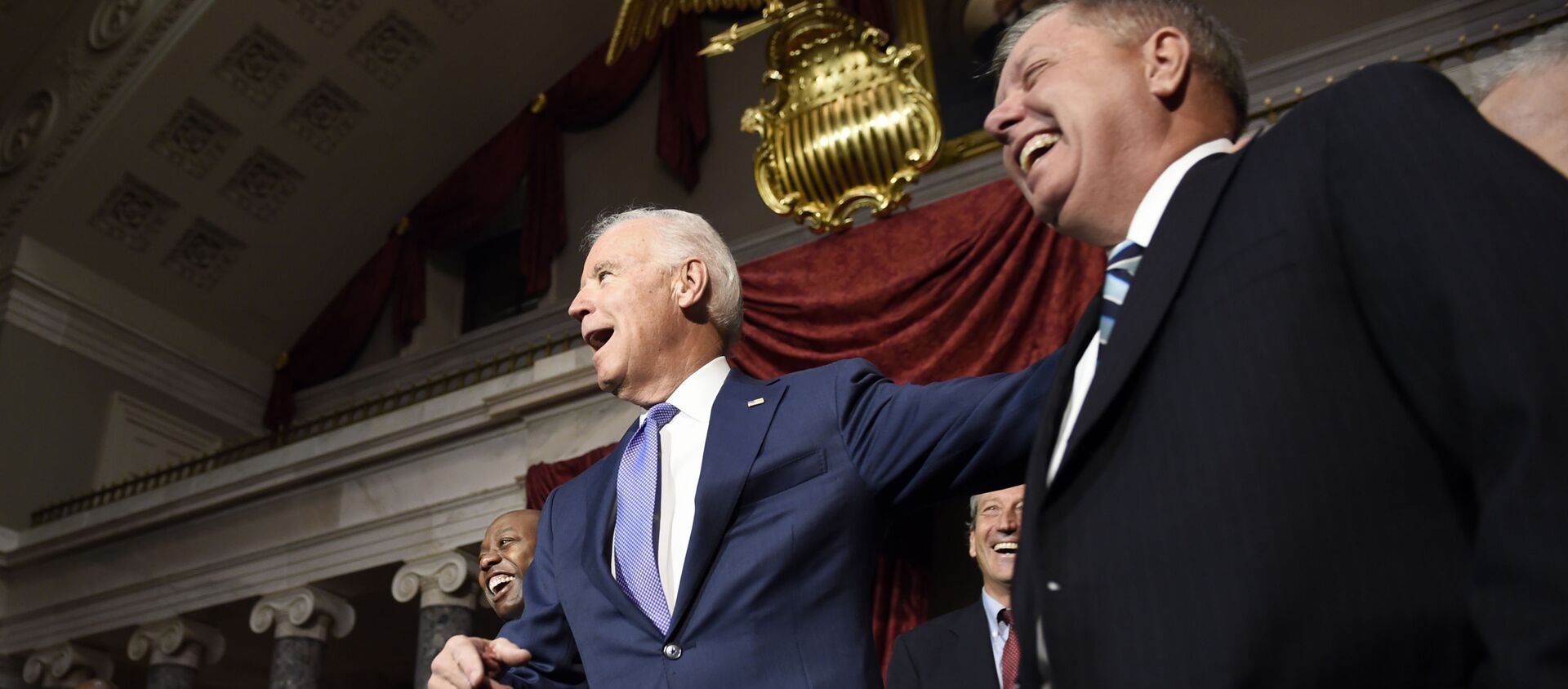 Vice President Joe Biden shares a laugh with Sen. Lindsey Graham, R-S.C., right, following a ceremonial swearing-in ceremony for Sen. Tim Scott, D-S.C., left, Tuesday, Dec. 2, 2014, in the Old Senate Chamber on Capitol Hill in Washington. Rep. Mark Sanford, R-S.C., is second from right - Sputnik International, 1920, 16.08.2021