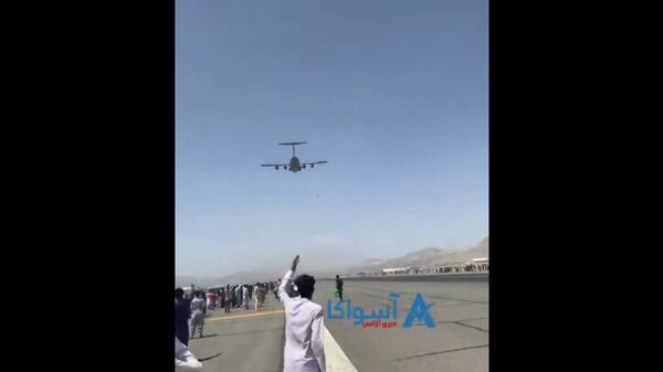 Exclusive- A clear video (from other angle) of men falling from C-17. They were Clinging to some parts of the plane that took off from Kabul airport today.  - Sputnik International
