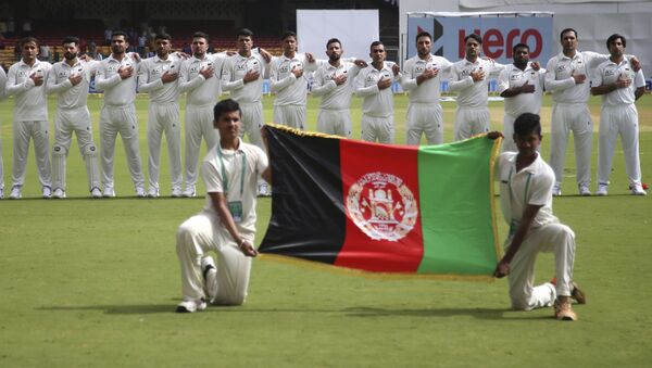 Members of Afghanistan cricket team stand for their national anthem before the start of the one-off test match against India in Bangalore, India, Thursday, June 14, 2018 - Sputnik International