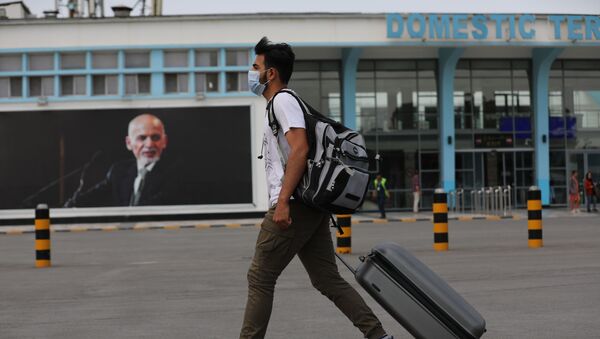 A passenger walks to the departures terminal of Hamid Karzai International Airport, in Kabul, Afghanistan, Saturday, Aug. 14, 2021. - Sputnik International