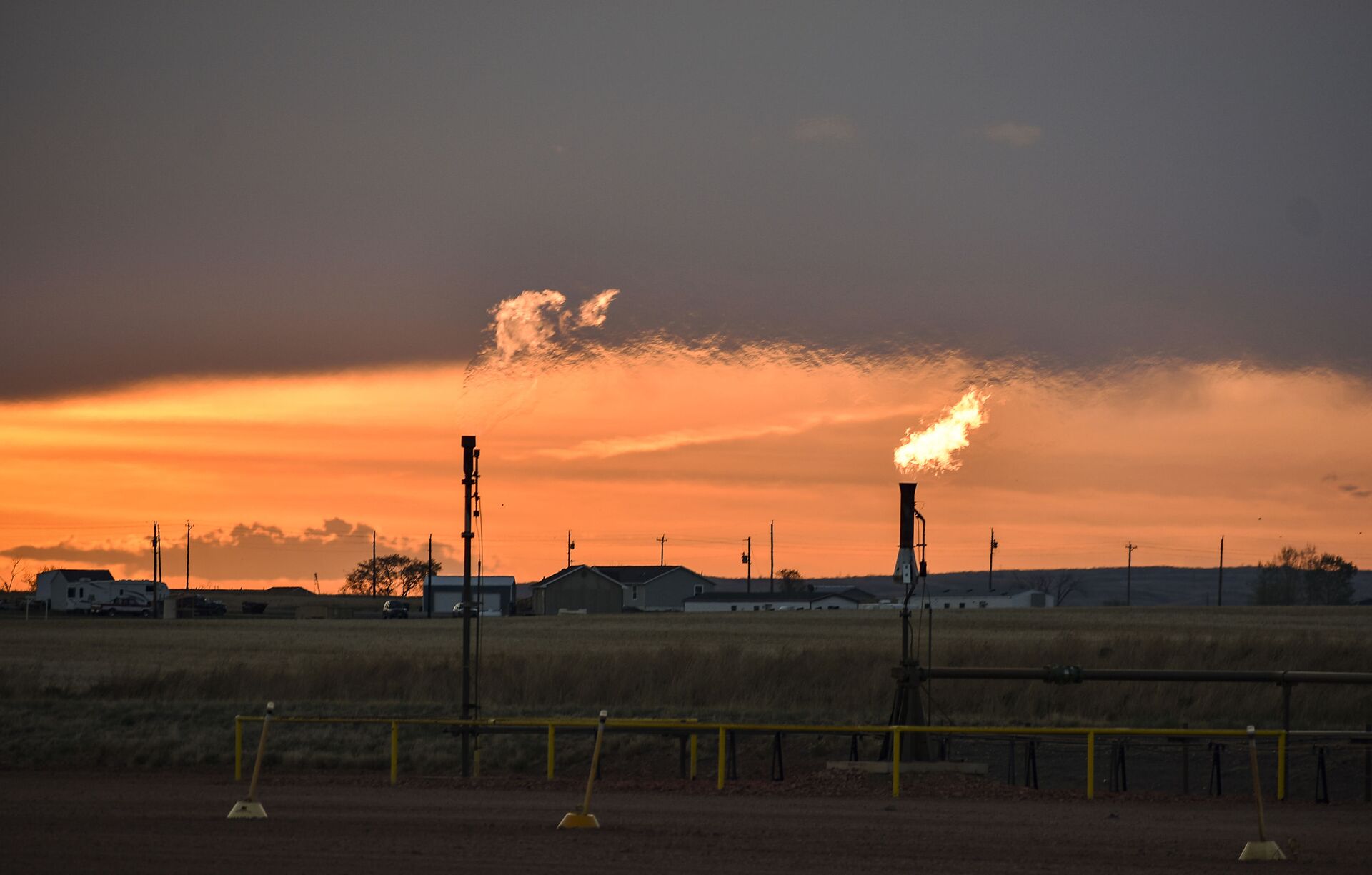 In this Tuesday, May 18, 2021, photo, flares burn natural gas from oil production in the Fort Berthold Indian Reservation east of New Town, North Dakota. - Sputnik International, 1920, 12.10.2021