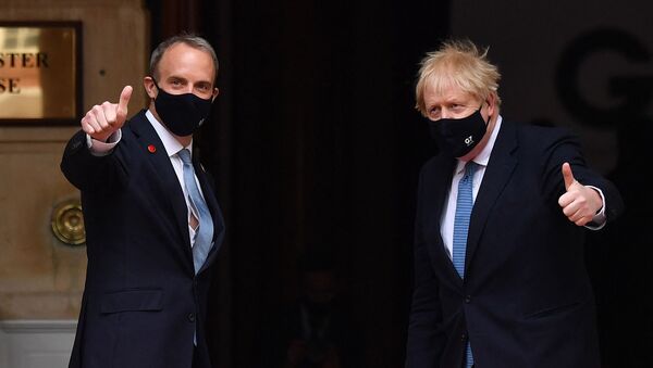 Britain's Prime Minister Boris Johnson (R) poses with Britain's Foreign Secretary Dominic Raab as he arrives at the G7 foreign ministers meeting in London on May 5, 2021 - Sputnik International