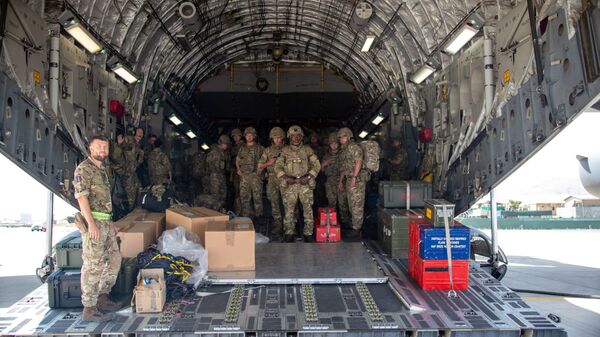 A handout picture taken and released by the British Ministry of Defence (MOD) on August 15, 2021 shows members of the British Army, from 16 Air Assault Brigade, as they disembark from an RAF Voyager aircraft after landing in Kabul, Afghanistan, to assist in evacuating British nationals and entitled persons as part of Operation PITTING - Sputnik International