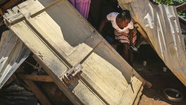 A woman walks in the rubble of her earthquake destroyed home as she attempts to recover her belongings, in Camp-Perrin, Les Cayes, Haiti, Sunday, Aug. 15, 2021. - Sputnik International